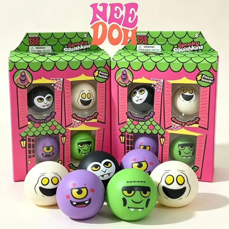 four mini squish balls with halloween faces white ghost one eyed purple monster green frankenstein black vampire